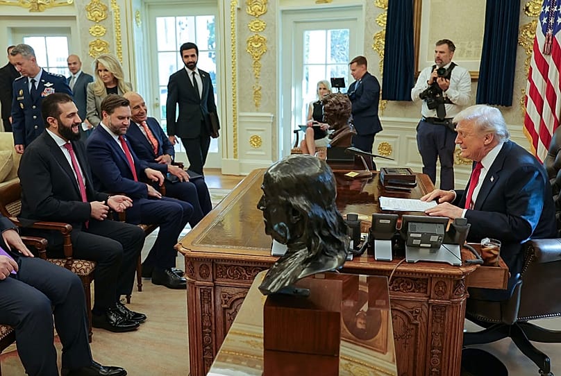 Suriye'nin geçici lideri Ahmet eş-Şara, ABD Başkanı Donald Trump ile yaptığı görüşmenin ardından Beyaz Saray'ın dışında destekçilerine el sallıyor, 10 Kasım 2025.