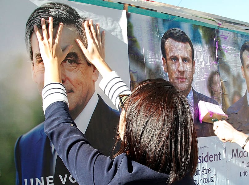 FILE: Supporters of conservative presidential candidate Francois Fillon glue campaign posters in Bayonne, southwestern France, 19 April 2017