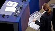 An assistant carries a box of voting ballots during the opening plenary of the newly-elected European Parliament in Strasbourg, eastern France, Tuesday, July 16, 2024. 