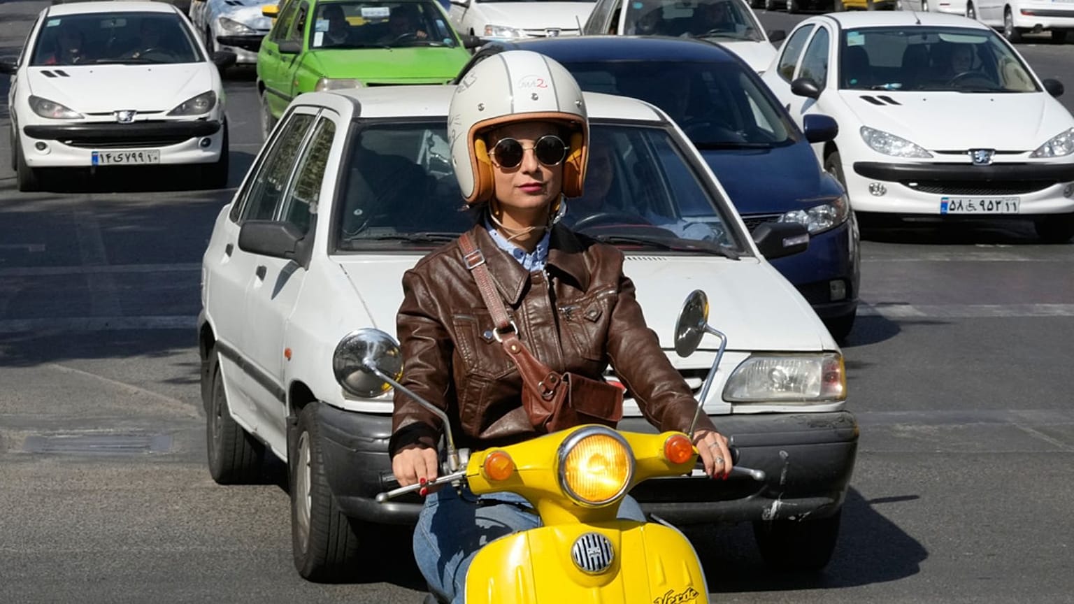 Merat Behnam drives her motorbike in downtown Tehran