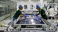 Workers put switches and connectors on solar panels after they come out of automated framing at a ReNew solar panel manufacturing plant on the outskirts of Jaipur, India.