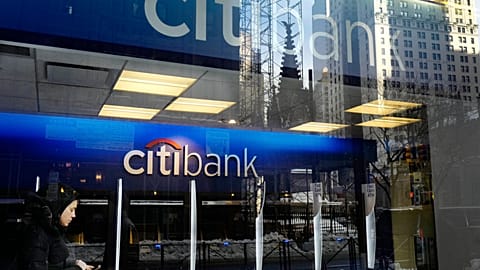 FILE - In this March 16, 2017, file photo, a customer enters a Citibank branch, in New York. 