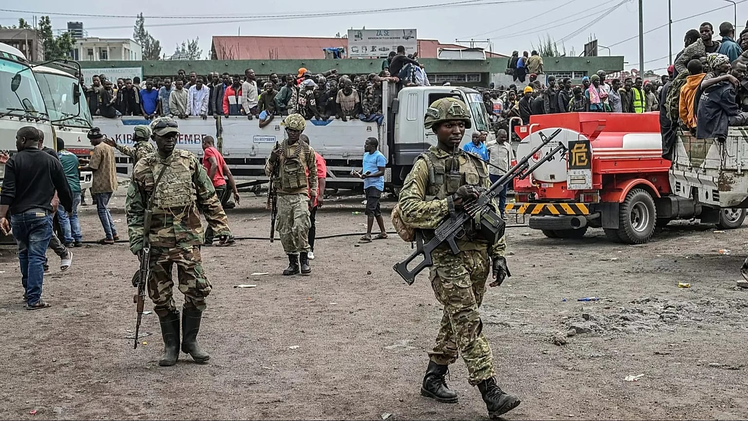 M23 rebels escort government soldiers and police who surrendered to an undisclosed location in Goma, 30 January, 2025