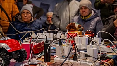 People charge their phones in a community tent in Chernihiv, 21 October, 2025