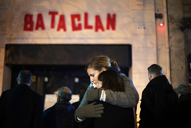 Women hug in front of the Bataclan concert hall in Paris on Nov. 13, 2016. 