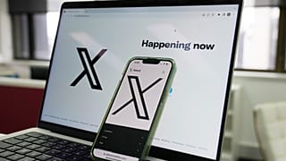 he opening page of X is displayed on a computer and phone, Oct. 16, 2023, in Sydney