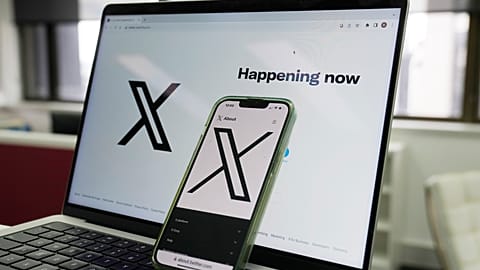he opening page of X is displayed on a computer and phone, Oct. 16, 2023, in Sydney