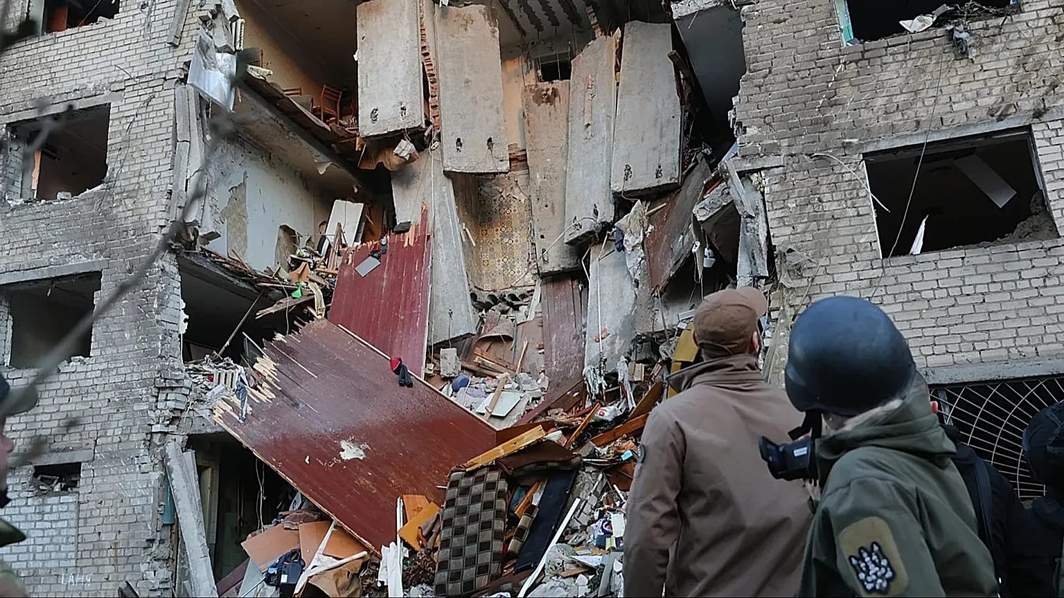Rescuers attend to the scene after a Russian missile hit a hostel in Zaporizhzhia, 30 October, 2025