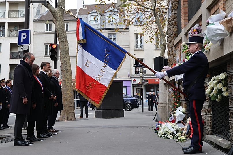 French President Emmanuel Macron and President of the association "13Onze15 Fraternite-Verite" Philippe Duperron pay their respect to victims near Le Bonne Biere cafe.