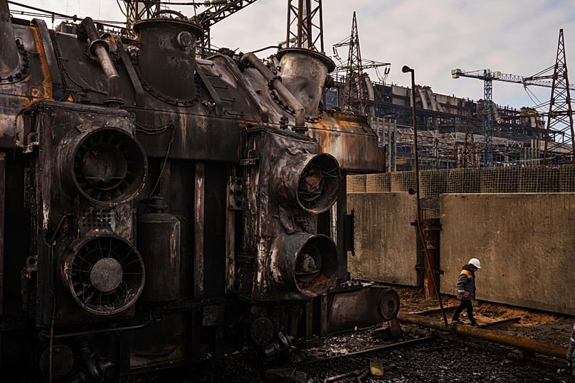 A worker walks in front of a transformer which was destroyed after a recent Russian missile attack at DTEK's power plant in Ukraine, Nov. 28, 2024.