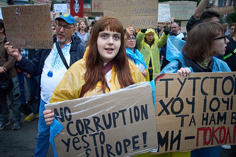 Participants hold banners during a protest against a law targeting anti-corruption institutions in front of the Presidential Office in Kyiv, Ukraine, Wednesday, July 30, 2025.