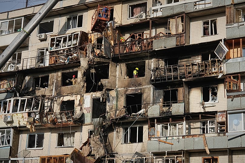 Rescuers work on the scene of a building damaged after a Russian attack in Kyiv, 14 November, 2025