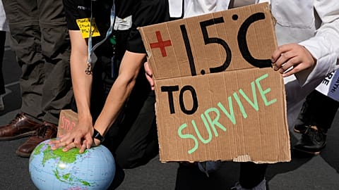 Demonstrators pretend to resuscitate the Earth while advocating for the 1.5 degree warming goal to survive at COP27 in Egypt in 2022. 