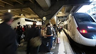 People board a train at the Montparnasse train station after a man wielding a knife was shot and wounded by police, 14 November, 2025 