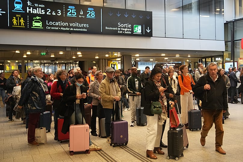 Travelers wait for their train at the Montparnasse train station after a man wielding a knife was shot and wounded by police, 14 November, 2025 