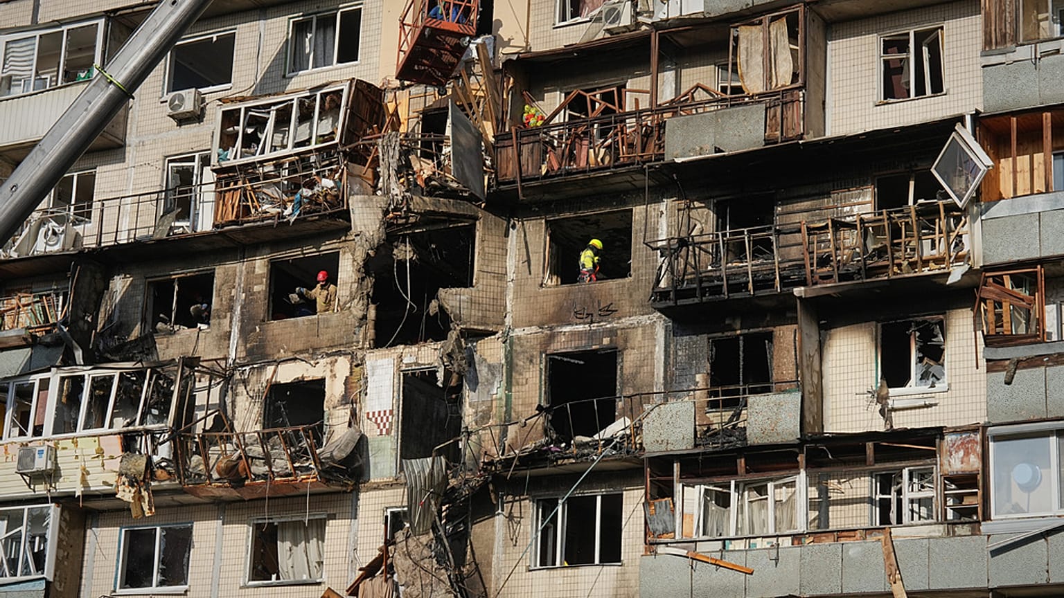 Rescuers work on the scene of a building damaged after a Russian attack in Kyiv, Ukraine, on Friday, 14, November 2025.