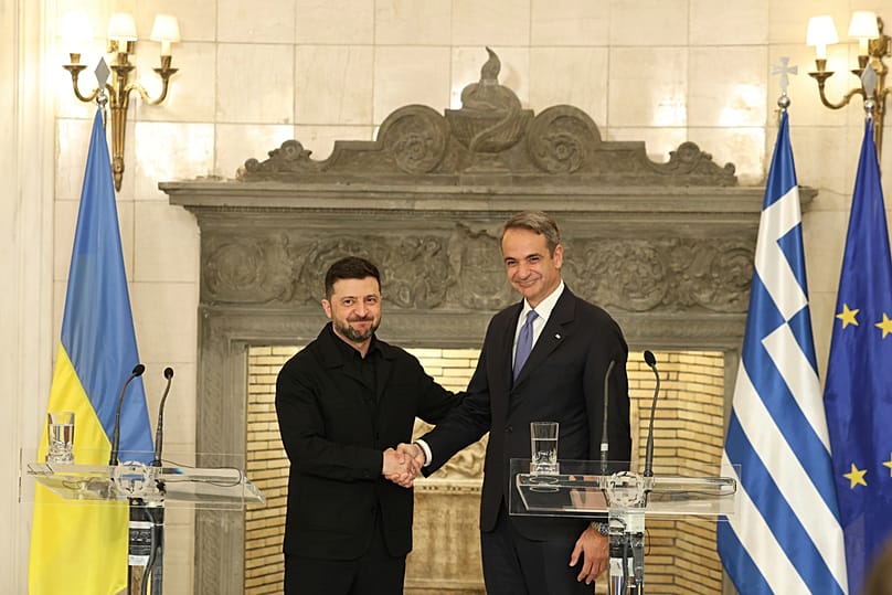 Greece's Prime Minister Kyriakos Mitsotakis, right, and Ukraine's President Volodymyr Zelenskyy shake hands after their statements at Maximos Mansion in Athens, Greece, Sunday
