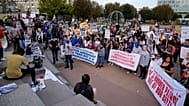 People protest against federal immigration enforcement Saturday, Nov. 15, 2025, in Charlotte, N.C. (AP Photo/Erik Verduzco)