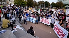 People protest against federal immigration enforcement Saturday, Nov. 15, 2025, in Charlotte, N.C. (AP Photo/Erik Verduzco)