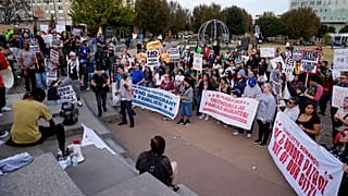 People protest against federal immigration enforcement Saturday, Nov. 15, 2025, in Charlotte, N.C. (AP Photo/Erik Verduzco)