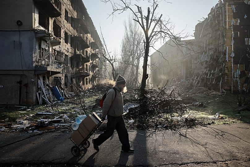 A resident goes along a street in the frontline town of Kostyantynivka, the site of heavy battles with the Russian troops in the Donetsk region, 15 November 2025