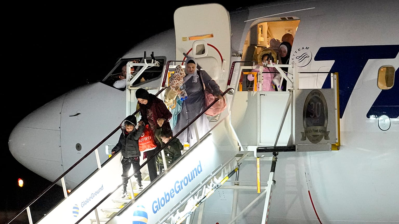 ينزل أشخاص تم إجلاؤهم من غزة من طائرة وصلت من مصر في قاعدة بازا 90 للقوات الجوية في أوتوپيني، رومانيا، يوم الأربعاء، 8 نوفمبر 2023