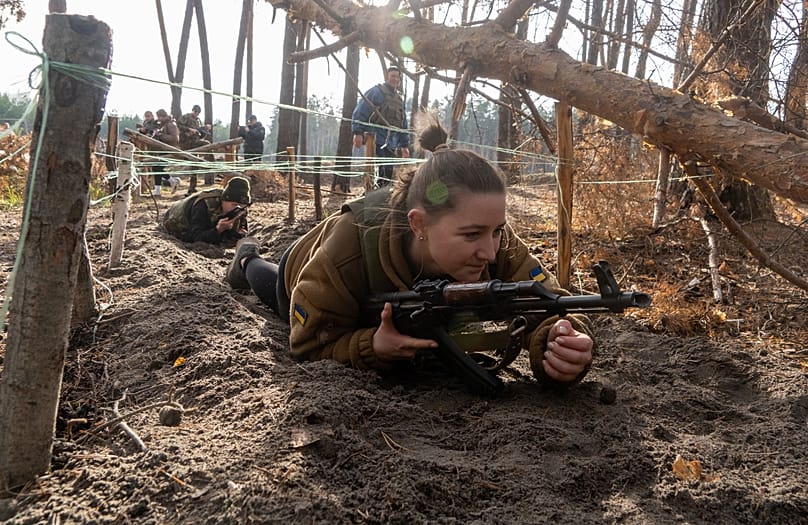 Civilians practice military skills on a training ground in Kharkiv region, Ukraine, Saturday, Nov. 15, 2025. 