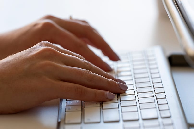 A person types on a keyboard 