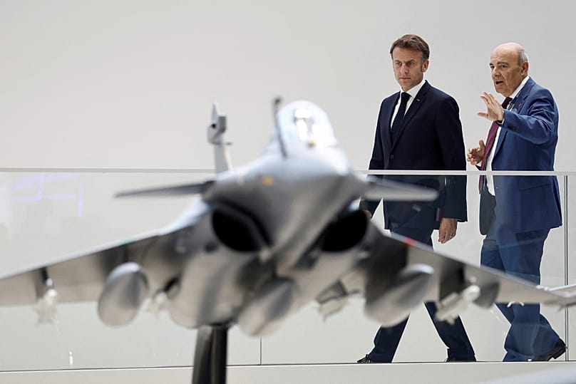 French President Emmanuel Macron looks at a display model of a Rafale fighter jet at the International Paris Airshow at Le Bourget Airport, 20 June, 2025