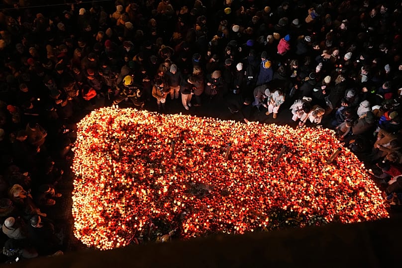 People gather to light candles to celebrate the 36th anniversary of the pro-democratic Velvet Revolution, in Prague, Czech Republic, Monday, Nov. 17, 2025.