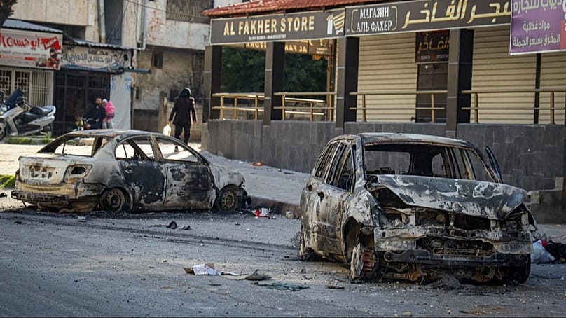 FILE: Burnt cars remain in the middle of a street following the recent wave of violence in the town of Jableh, Syria's coastal region, 10 March, 2025.