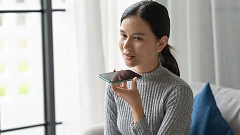 A woman talks into her phone.