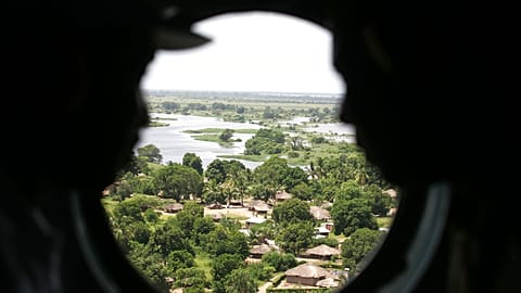 FILE: Mozambican military officers look through a helicopter window as it flies above the flooded area near Caia, northern Mozambique, 14 February 2007 (illustration)