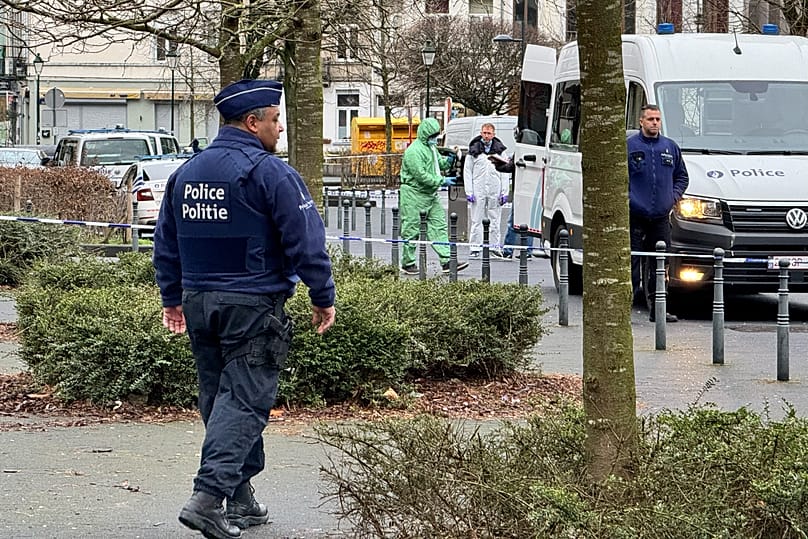 A forensic team and police officers investigate at the scene of a shooting in Brussels, 14 February, 2024
