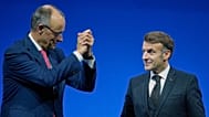 German Chancellor Friedrich Merz, left, reacts to French President Emmanuel Macron during a Summit on European Digital Sovereignty in Berlin, Germany, Tuesday, Nov. 18, 2025.