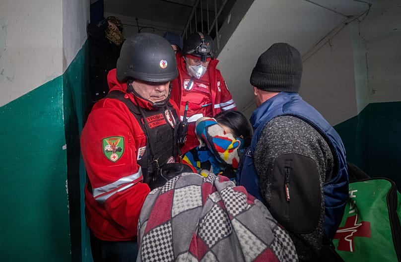 Rescuers evacuate an injured civilian after a residential building was hit following Russia's missile attack in Kharkiv, Ukraine Wednesday, Nov. 19, 2025. 