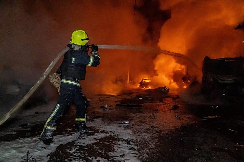Rescue workers put out a fire of a residential building damaged by a Russian strike on Kharkiv, Ukraine, Wednesday, Nov. 19, 2025.