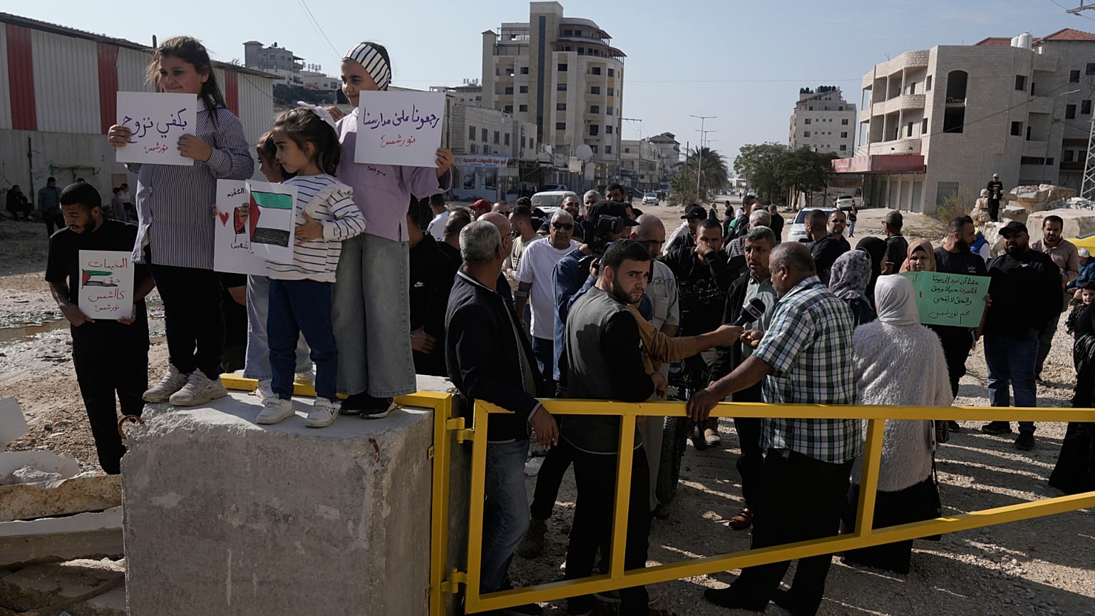 Displaced Palestinians gather during a protest calling to return to their houses in the Nur Shams refugee camp, in the West Bank city of Tulkarem, Tuesday, Nov. 18, 2025.