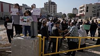 Displaced Palestinians gather during a protest calling to return to their houses in the Nur Shams refugee camp, in the West Bank city of Tulkarem, Tuesday, Nov. 18, 2025.