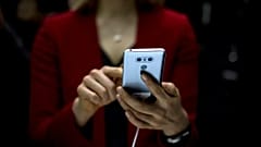 FILE: A woman uses mobile phone in Italy