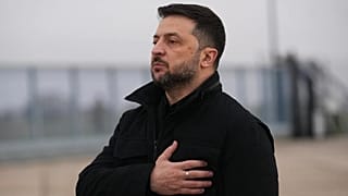Ukrainian President Volodymyr Zelenskyy listens his national anthem as he arrives at the Villacoublay air base near Paris, Monday, Nov. 17, 2025 