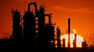 The HF Sinclair El Dorado oil refinery is silhouetted against the sky at sunset March 21, 2025, in El Dorado, Kan.