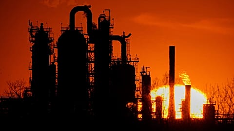 The HF Sinclair El Dorado oil refinery is silhouetted against the sky at sunset March 21, 2025, in El Dorado, Kan.