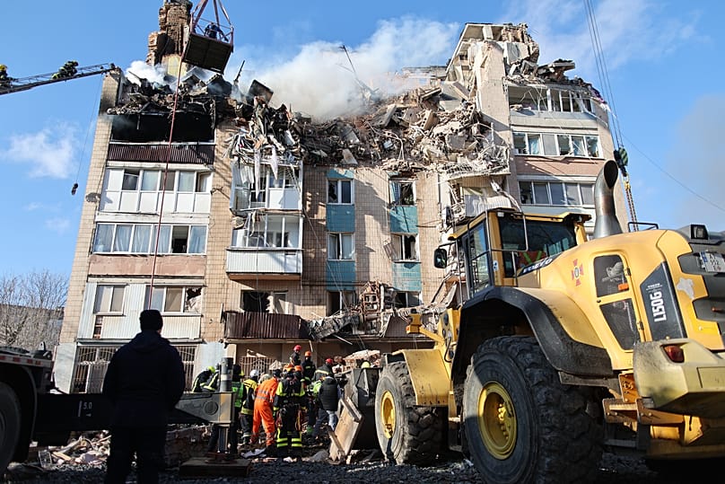 Rescue workers clear the rubble of a residential building which was heavily damaged by a Russian strike on Ternopil, 19 November, 2025