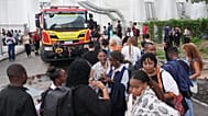 Attendees evacuate after a fire was reported inside the venue for the COP30 U.N. Climate Summit, Thursday, Nov. 20, 2025, in Belem, Brazil. 