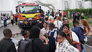 Attendees evacuate after a fire was reported inside the venue for the COP30 U.N. Climate Summit, Thursday, Nov. 20, 2025, in Belem, Brazil. 