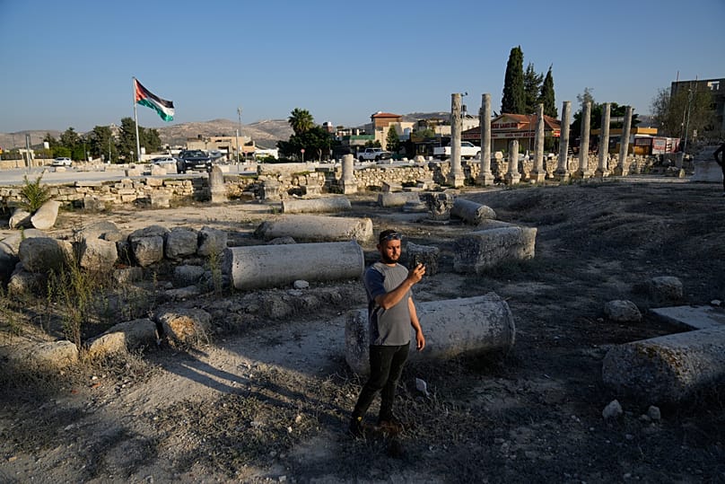 A Palestinian visitor takes a photo at the Roman historical site in the West Bank town of Sebastia Thursday, Nov. 20, 2025.