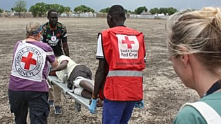 طاقم طبي من اللجنة الدولية للصليب الأحمر ينقل شخصًا مصابًا بطلق ناري في أكوبو، جنوب السودان، السبت 24 مايو 2025.