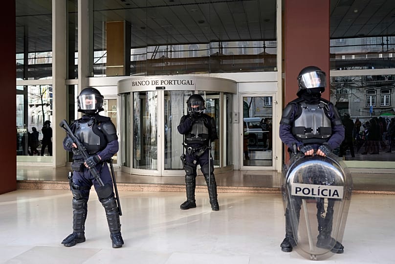 Police stand outside a building of the Bank of Portugal in Lisbon, 24 February, 2024