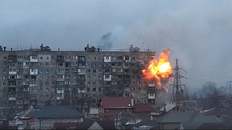 FILE - An apartment building explodes after Russian army tank fire in Mariupol, Ukraine, March 11, 2022